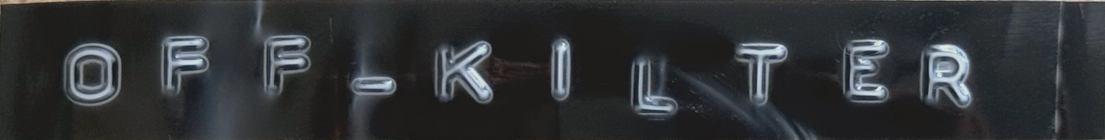 off_kilter, embossed on a strip of Dymo tape